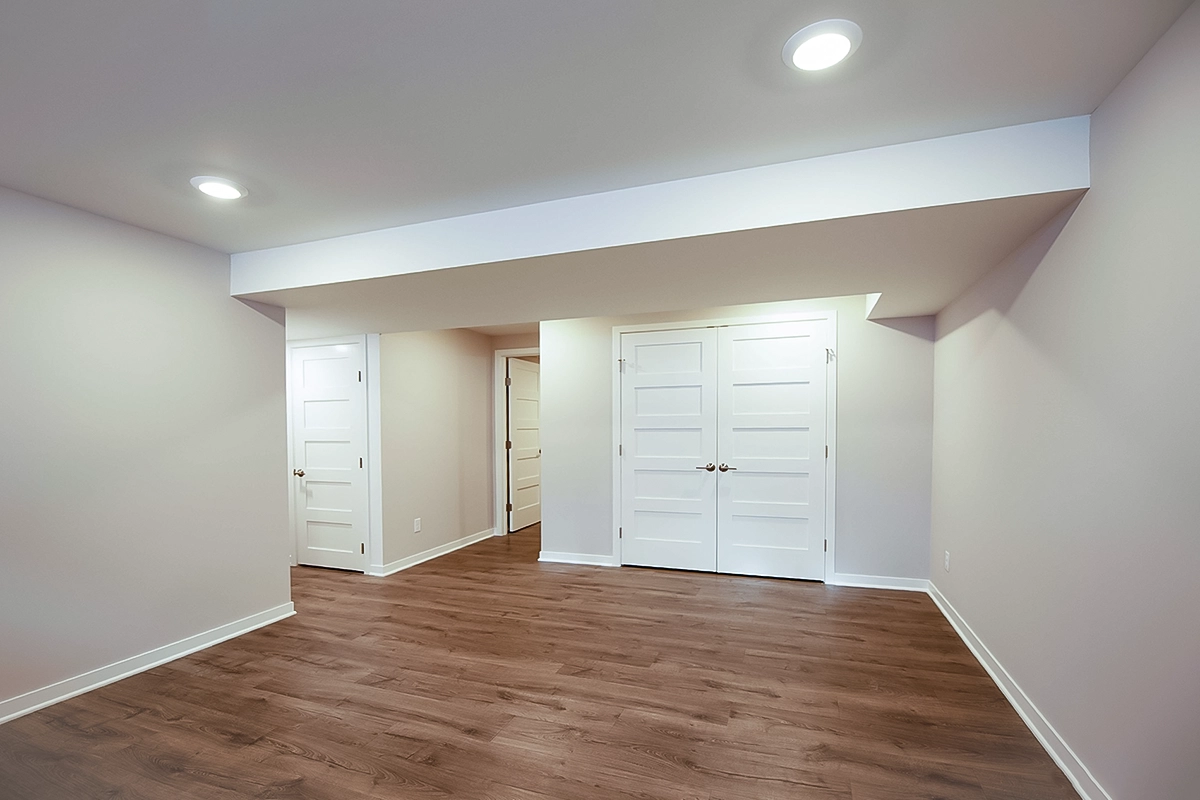 Modern finished basement living room with recessed lighting and LVP flooring in Coon Rapids MN