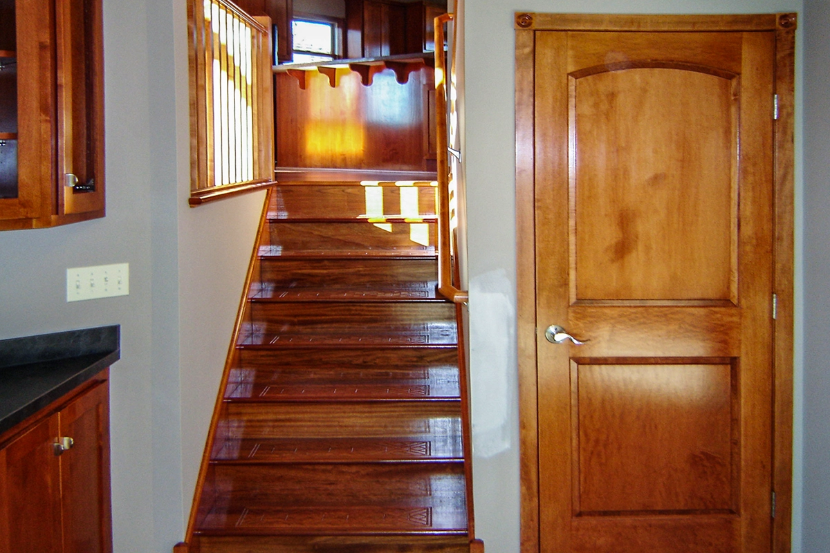 Andover MN custom maple stairs featuring decorative engraved step details and fine wood millwork