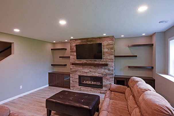Finished Basement with floating shelves and custom fireplace in Blaine MN