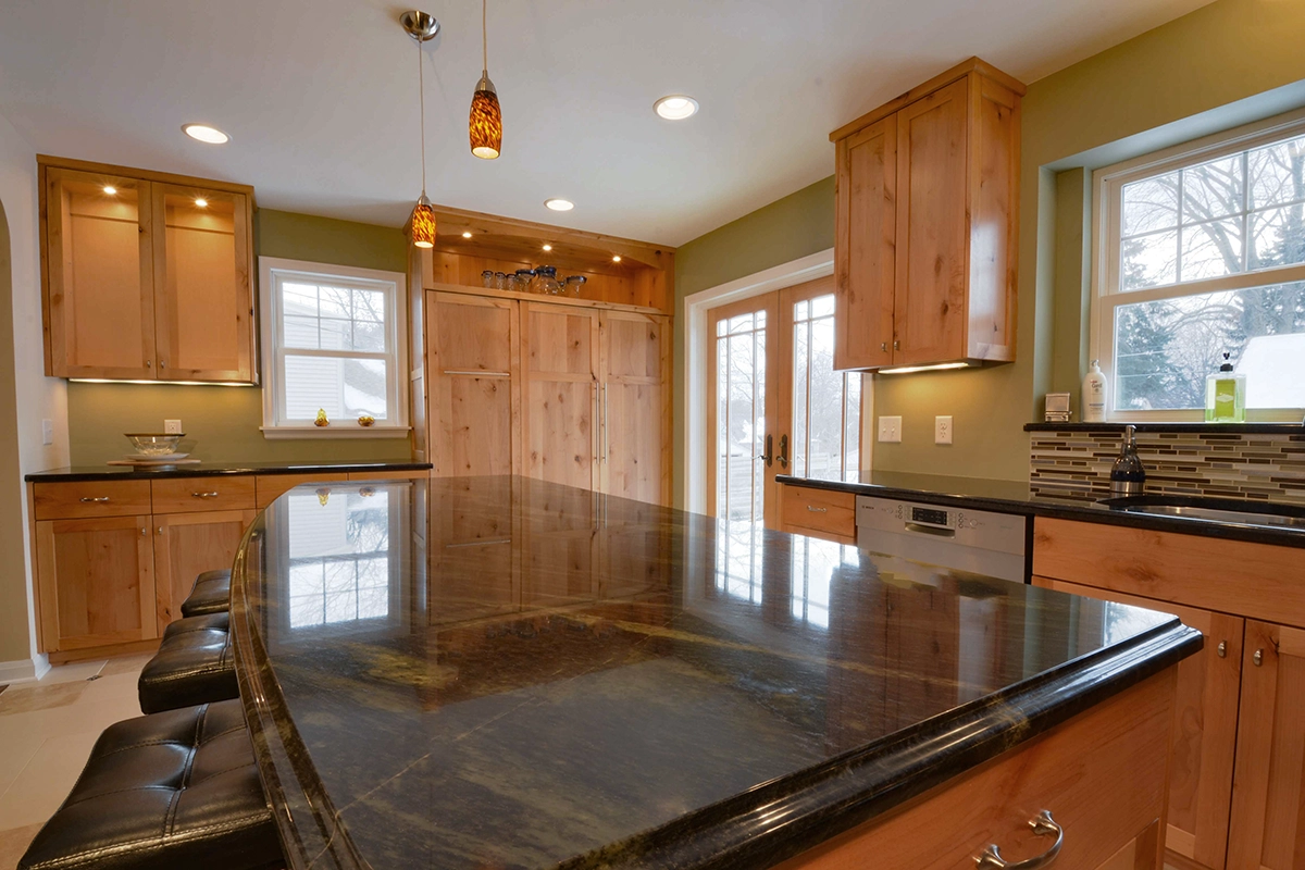 Blaine MN kitchen renovation showcasing rich alder cabinetry and granite island
