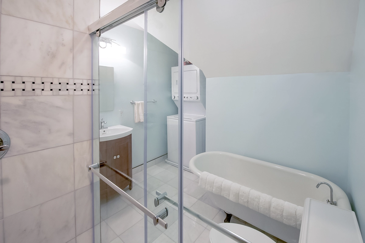Completed master bathroom suite expansion with cast iron soaking tub and laundry in Maple Grove MN